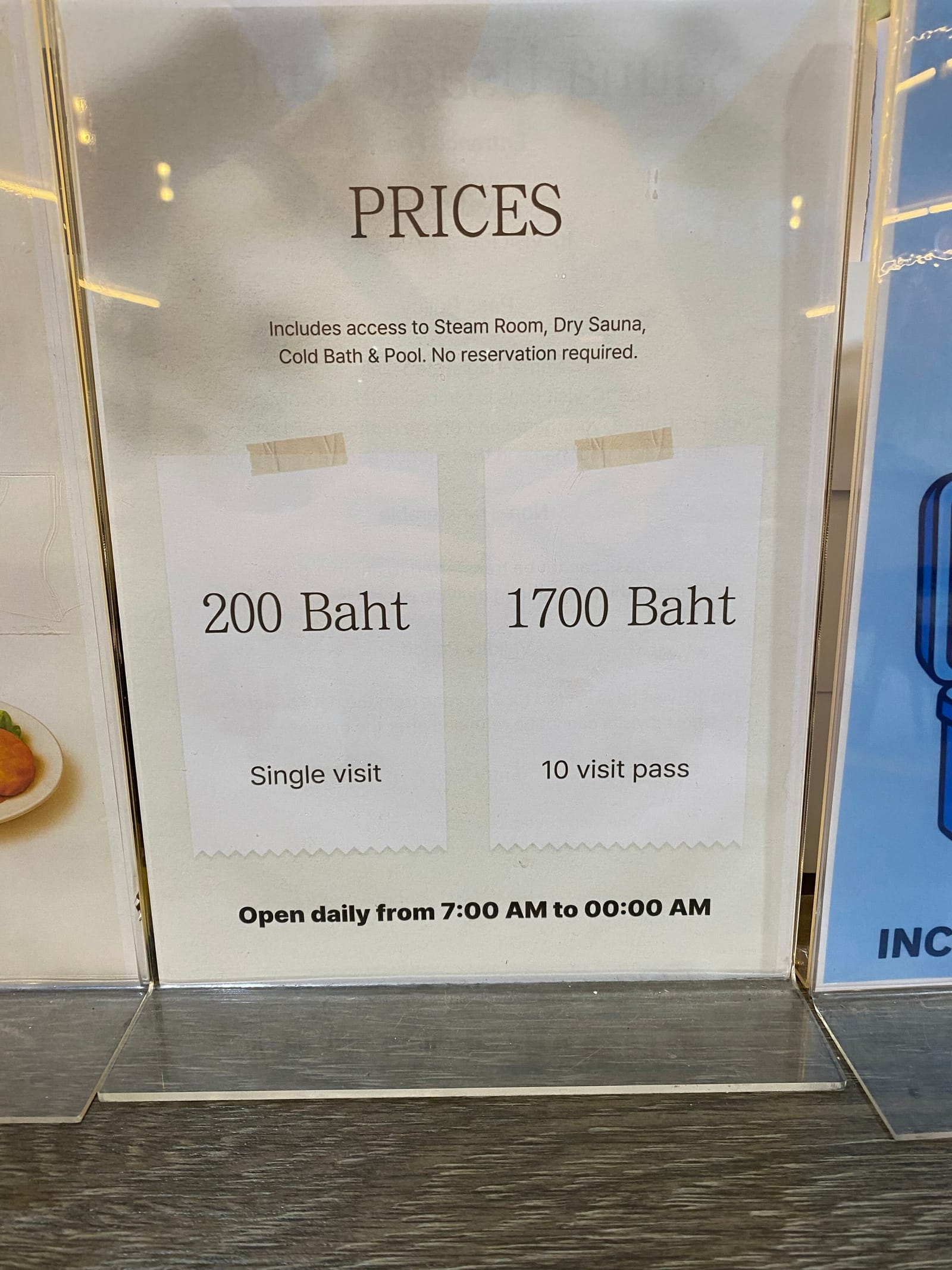 Price board reading 200 Baht single visit, 1700 Baht 10 visit pass, including steam room, dry sauna, cold bath and pool